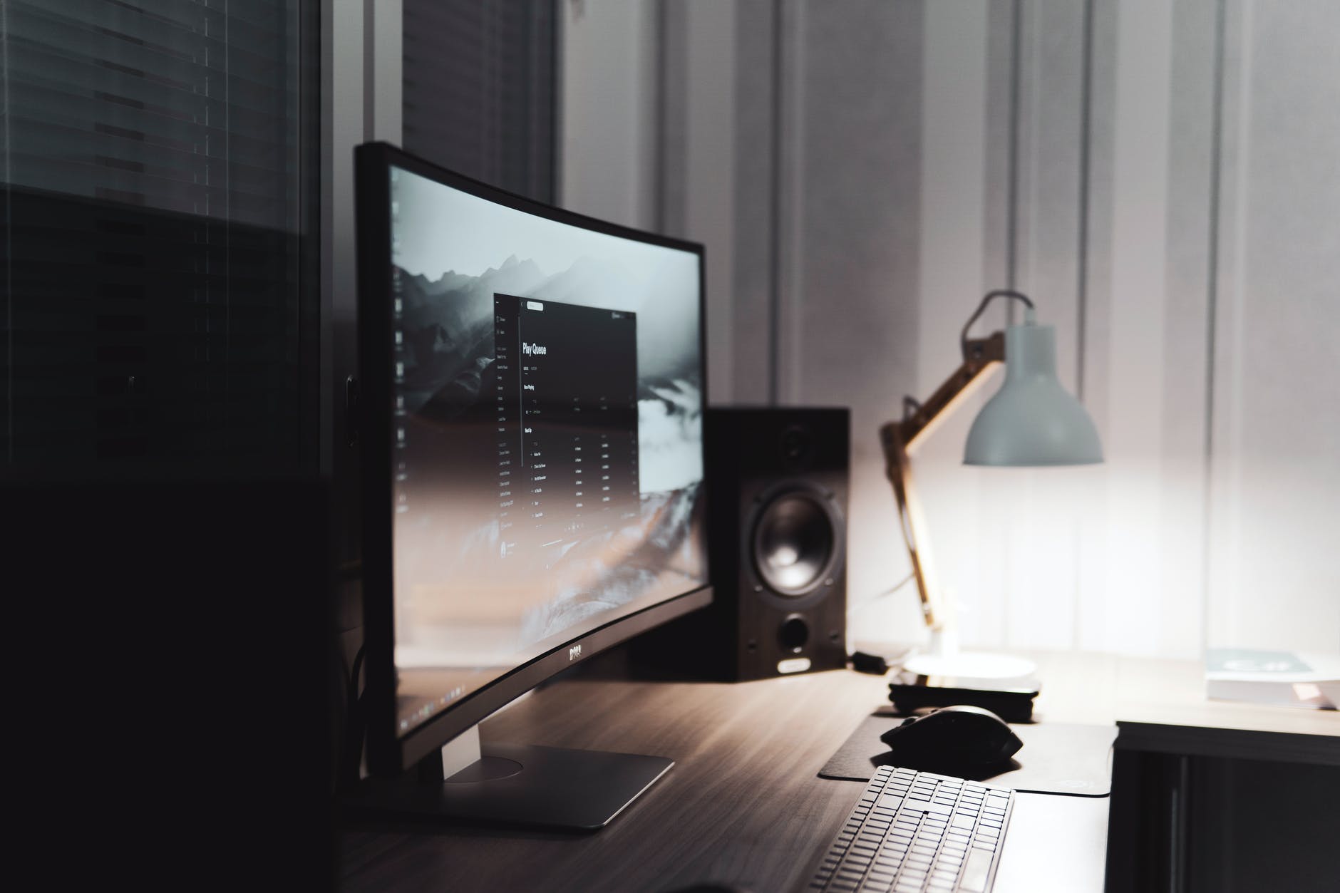 black flat screen computer monitor beside black speaker